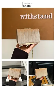 Detailed macro view of khaki velvet mini crossbody bag with gold chain and metal buckle