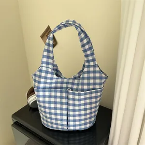 Blue and white checkered canvas tote bag with dual front pockets for daily essentials