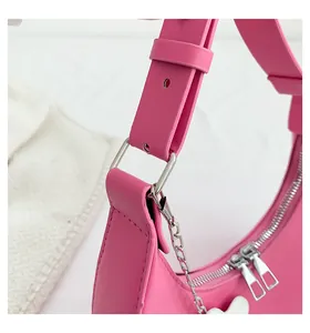 Detail of hot pink crescent hobo bag with silver double zippers and wide strap