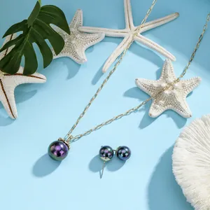 Detail of Hawaii style gold necklace and earring set with iridescent shell pearls