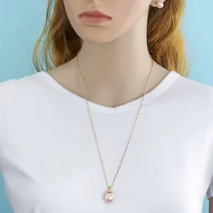 Detail of elegant gold-plated necklace and pearl earrings on a female model display