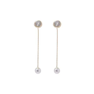Close-up of gold dangle earrings featuring shell inlays, long snake chains and faux pearls