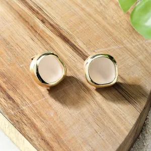 Bohemian sea glass earrings with gold plating on a natural wooden background