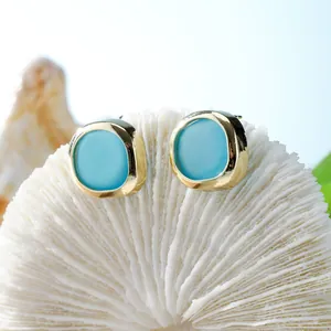 Bohemian sea glass stud earrings with gold plating and sky blue geometric stones