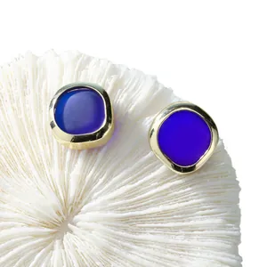 Bohemian sea stone stud earrings with deep blue glass and gold plating on coral base