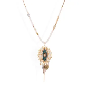 Bohemian beaded necklace with pink crystals, golden tassels and vintage pendant