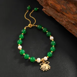Detail of vintage green stone and pearl bracelet with gold adjustable toggle and pendant