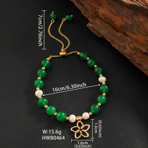 Detail view of pearl and green jade bracelet with gold flower pendant and size chart