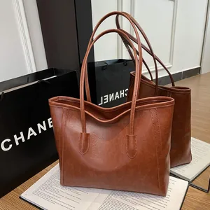 Vintage caramel faux leather tote bag with a spacious interior and long shoulder straps