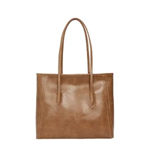 Vintage brown leather tote bag with long handles and a minimalist square design