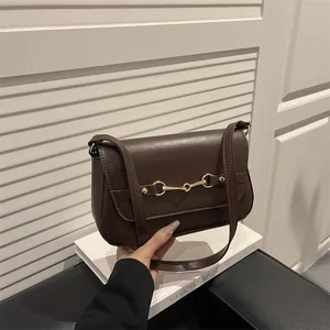 Minimalist dark brown leather shoulder bag with gold horsebit buckle decoration