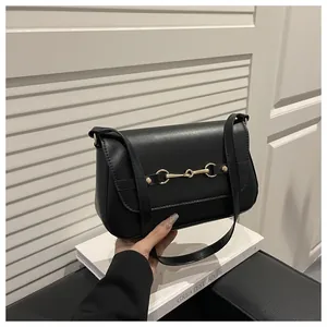 Classic black leather shoulder bag with gold horsebit hardware and adjustable strap