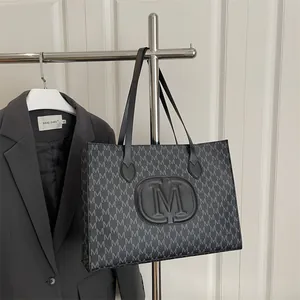 Classic charcoal grey tote bag with all-over M monogram pattern and round leather logo