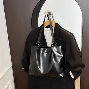 Fashion black glossy tote bag with silver bow detail and large capacity for commuting