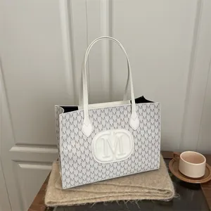 Minimalist grey and white tote bag with M letter pattern and elegant leather handles