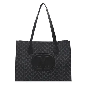 Classic black tote bag with monogram print and embossed M logo for daily commuting