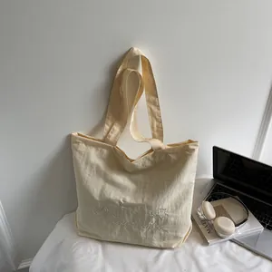 Minimalist beige canvas tote bag with delicate heart embroidery for women's casual style