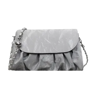 Silver pleated shoulder bag with metallic finish and decorative chain detail