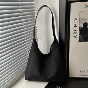 Minimalist black suede tote bag with large capacity and sleek shadow lighting effect