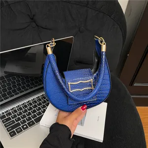 Klein blue half-moon shoulder bag with stone pattern and golden metal buckle details