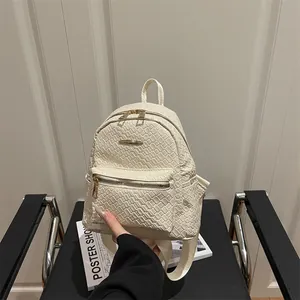 Fashionable beige woven PU leather backpack with gold metal zippers and top handle