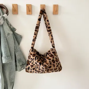 Chic leopard print plush tote bag with furry strap on wall hook with denim jacket