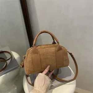 Brown suede Boston handbag with minimalist vintage matte texture and versatile crossbody strap
