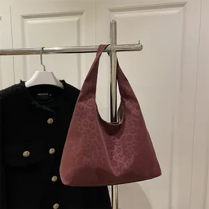Fashionable burgundy leopard print suede hobo bag with wide shoulder strap