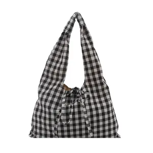 Minimalist black and white gingham tote bag with stylish bow tie closure on white background