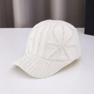 Detail of white knitted baseball cap with vibrant rhinestones and warm fuzzy texture