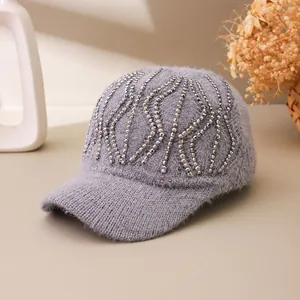Close-up of grey knit baseball cap featuring luxury rhinestone wave patterns and texture