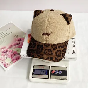 Detail view of lightweight leopard print plush baseball cap weighing 119g on a digital scale