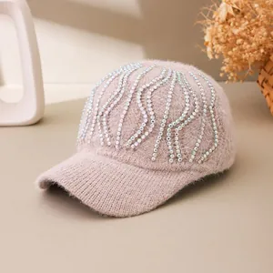 Close-up of sparkling rhinestones and plush knit texture on a pink baseball cap