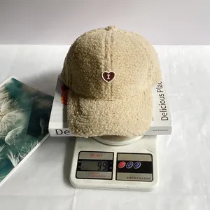 Berretto in pile beige su una bilancia che mostra il design leggero di soli 99g di peso