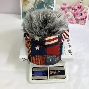 Detail view of hip hop wig baseball hat with USA flag brim on a scale weighing 70 grams
