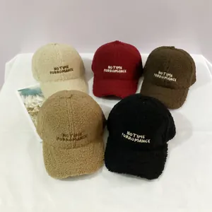 Multiple teddy fleece baseball caps in various colors featuring NO letter embroidery