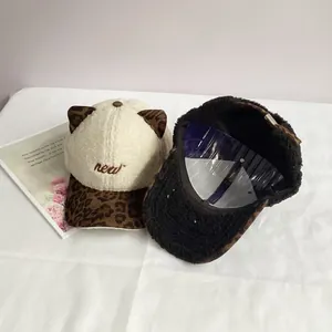 Detail of plush leopard print cat ear baseball cap with embroidered new lettering