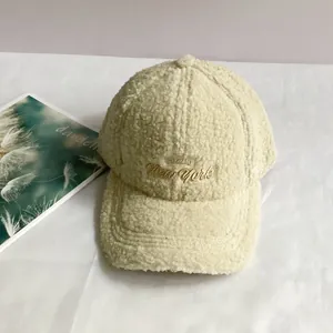 Close-up of beige fleece baseball cap with New York embroidery and soft fuzzy texture