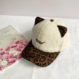 Close-up of plush baseball cap with cute cat ears, leopard print brim and new embroidery