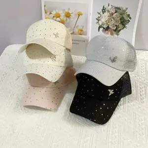 Detail of sequined mesh baseball caps with silver butterfly badges in five colors