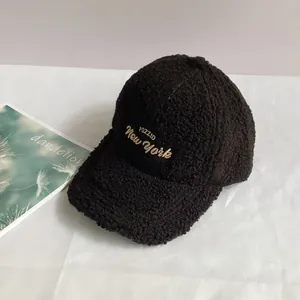 Detailed close-up of warm black sherpa baseball cap with yellow Pozzid embroidery