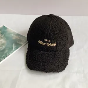 Detailed macro view of black lamb wool baseball cap featuring premium gold FOZZID embroidery