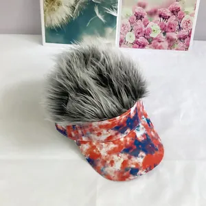 Detail of red white and blue tie-dye sun visor featuring shaggy grey faux hair wig