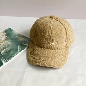 Close-up of FOZZID New York gold embroidery on soft camel lamb wool baseball cap