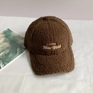Detailed close-up of dark brown sherpa baseball cap featuring PUZZID New York embroidery