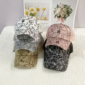 Detail view of glitter graffiti baseball caps in five colors with mesh back design