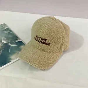 Detail of beige sherpa baseball cap featuring NO TIME FOR ROMANCE embroidery