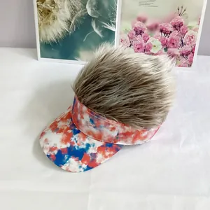 Detail of colorful tie-dye visor hat with realistic brown synthetic wig on top