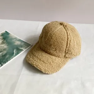 Close-up of beige fleece baseball cap featuring detailed New York letter embroidery