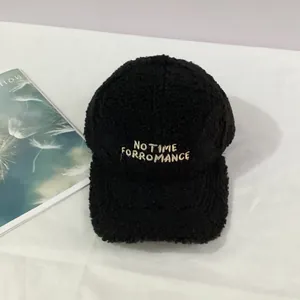 Close-up of black fleece baseball cap with white NO TIME FOR ROMANCE embroidery